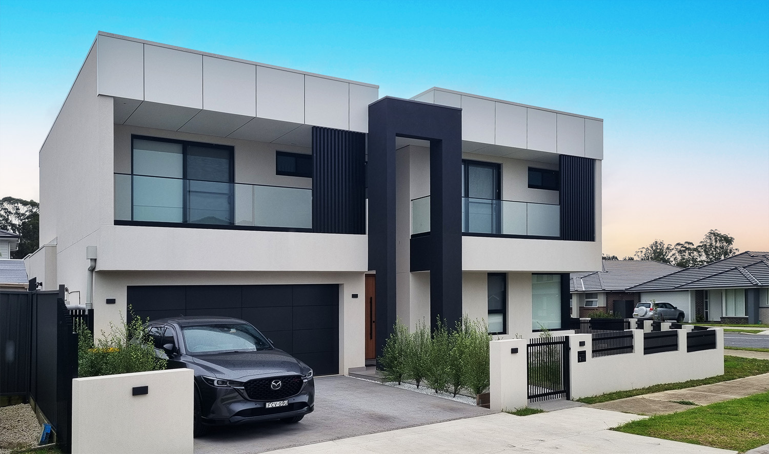 Photograph of the completed Edmondson Park house from the corner, showing the dual street frontage and secondary dwelling massing